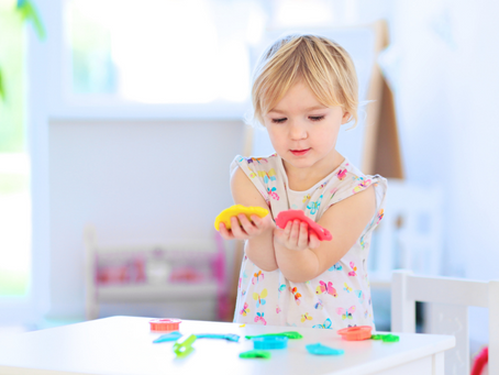 little girl playing with colorful toys at little explorers adventure park