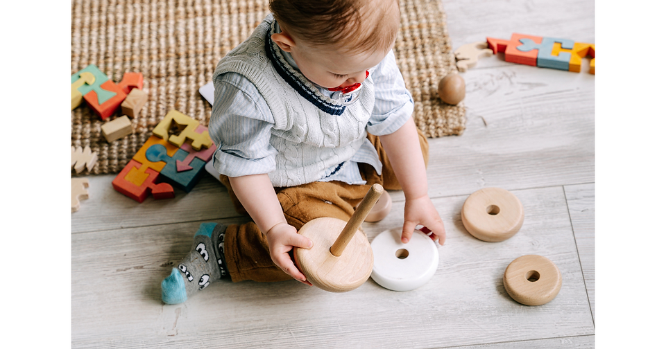 little boy playing with wooden toys