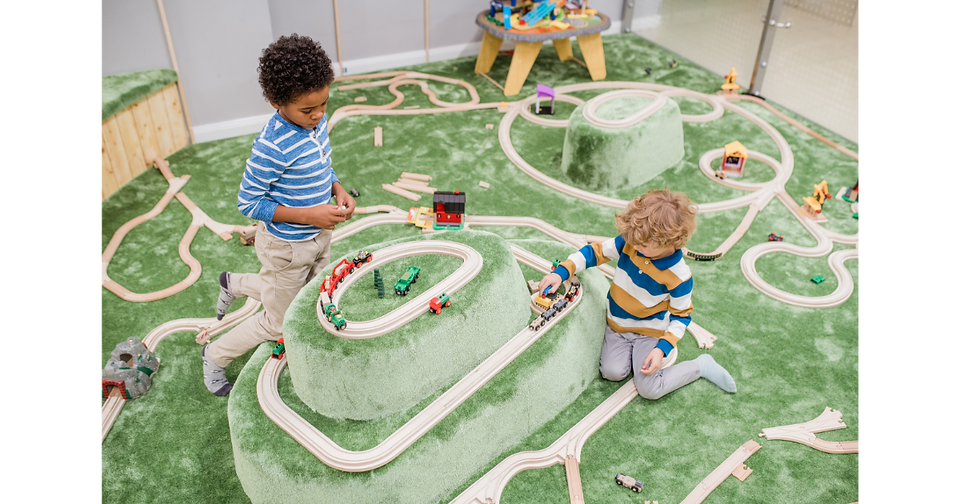 kids playing with a train set at little explorers adventure park 