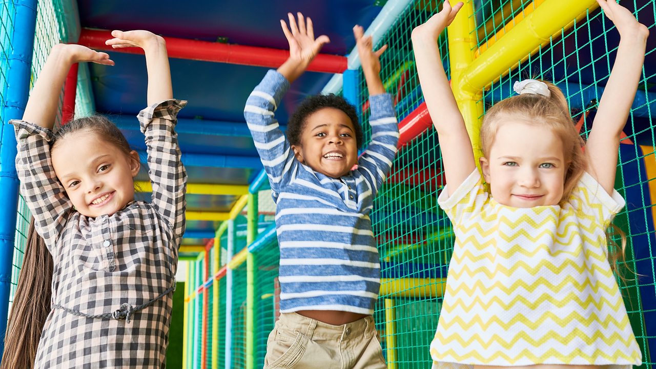 excited kids playing on indoor play structure