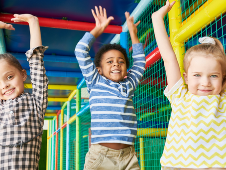 excited kids playing on indoor play structure
