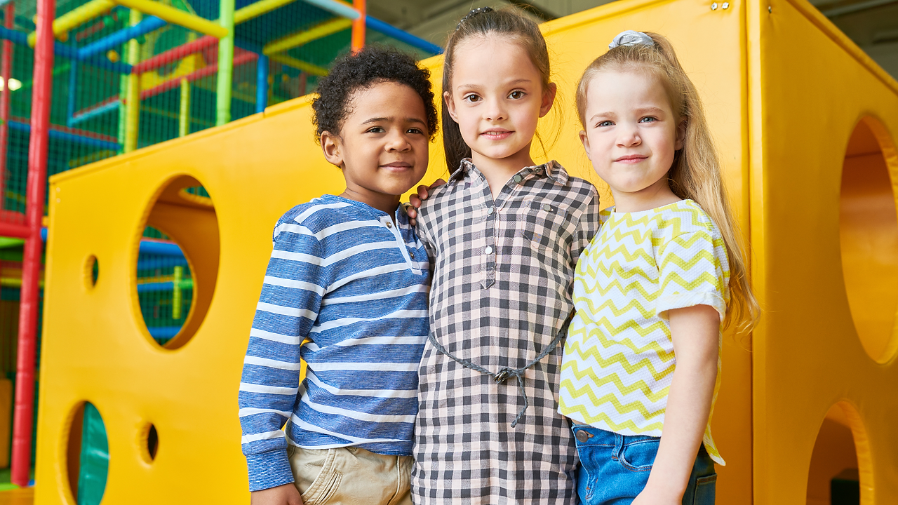 excited kids playing on indoor play structure