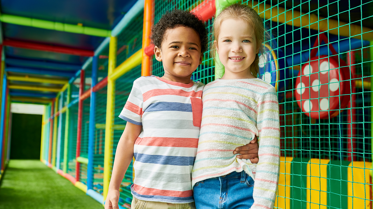 excited kids playing on indoor play structure